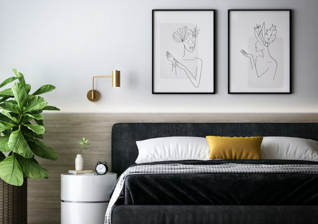 Modern bedroom interior with line art wall decor, green plant, and a pop of yellow on bed cushions.