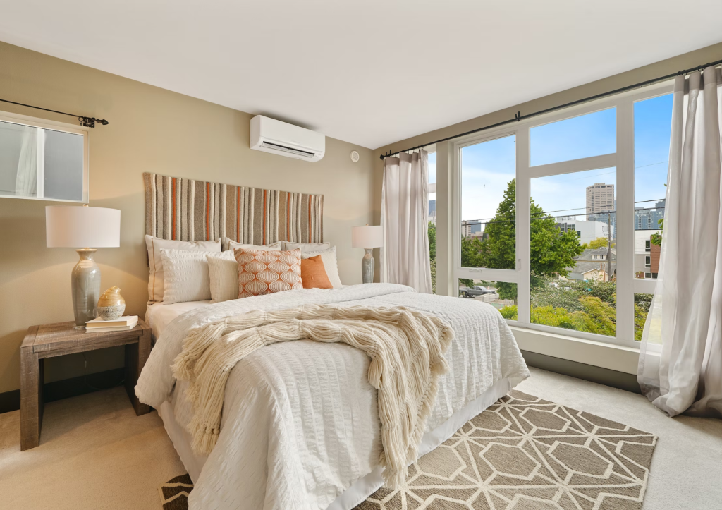 Bright, modern bedroom with large windows and a city view.